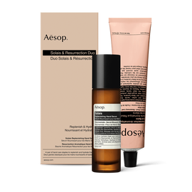 A pump bottle of Solais Replenishing Hand Serum and a tube of Resurrection Aromatique Hand Balm together in a carboard box.
