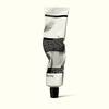 A front view of Parsley Seed Facial Cleansing Masque in an alabaster and black aluminium tube, gently crumpled from application.