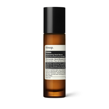 Solais Replenishing Hand Serum in a glass bottle.