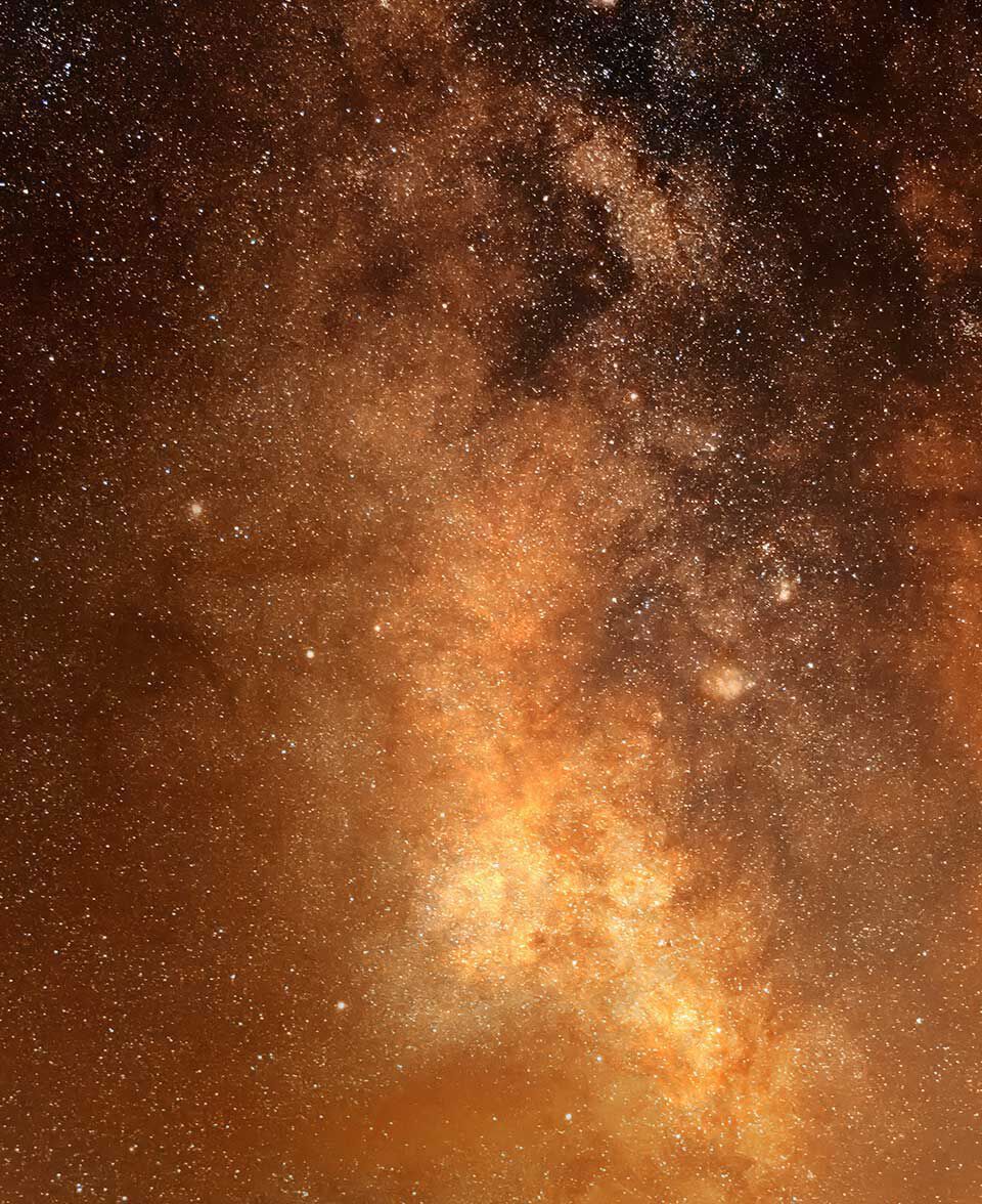 Dense star field with warm amber and gold tones across the night sky.