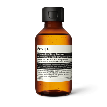 Aesop Geranium Leaf Body Cleanser in a small amber bottle with a black flip-top cap and cream label on a white background.